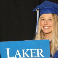 holding up props at GradFest for a picture